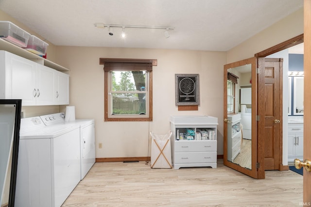 1205 Norma Jean Dr, Lafayette, IN 47909 - laundry area featuring washer and dryer, cabinet space, light wood-type flooring, and rail lighting