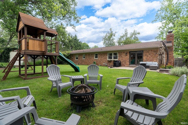 1205 Norma Jean Dr, Lafayette, IN 47909 - view of yard featuring a playground, an outdoor living space with a fire pit, a patio area, and french doors