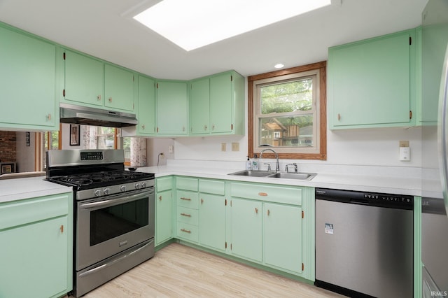 1205 Norma Jean Dr, Lafayette, IN 47909 - kitchen featuring appliances with stainless steel finishes, under cabinet range hood, light wood-style flooring, and light countertops