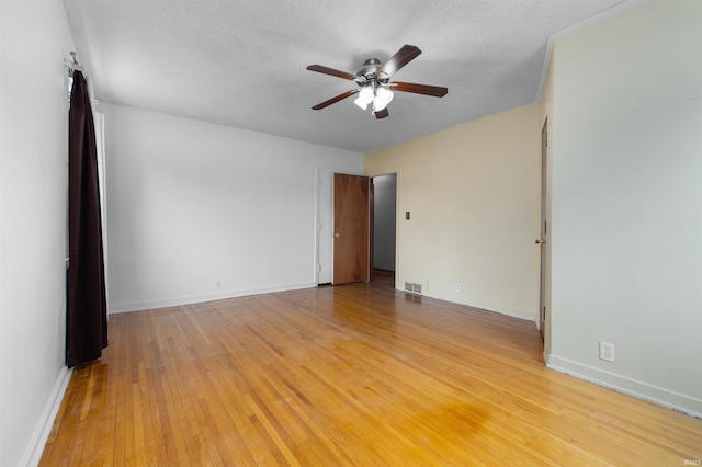 501 N Van Buren St, Auburn, IN 46706 - empty room with ceiling fan, light wood-style floors, and a textured ceiling