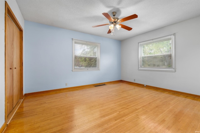 501 N Van Buren St, Auburn, IN 46706 - unfurnished bedroom with a closet, multiple windows, light wood-type flooring, and ceiling fan