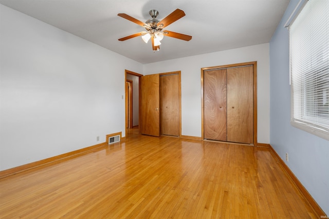 501 N Van Buren St, Auburn, IN 46706 - unfurnished bedroom with light wood-style flooring, two closets, and a ceiling fan