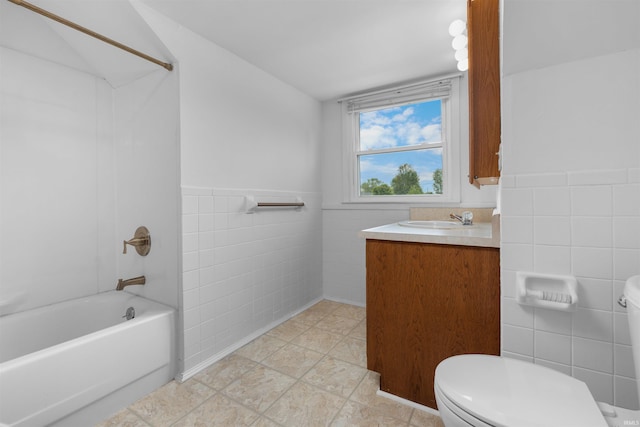 501 N Van Buren St, Auburn, IN 46706 - full bath featuring tile walls, vanity, bathing tub / shower combination, and a wainscoted wall