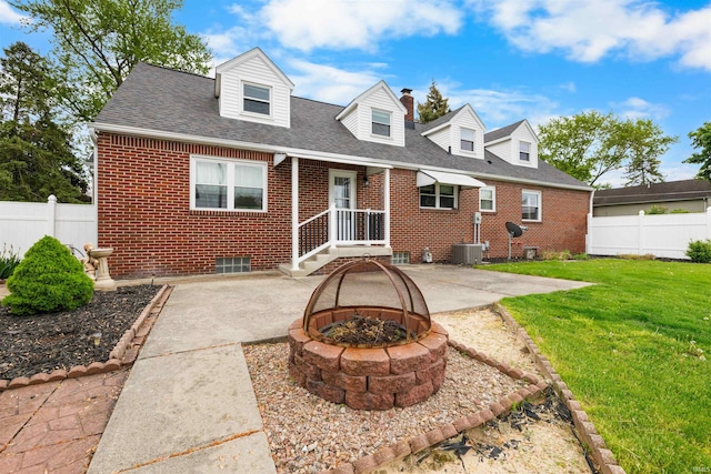 501 N Van Buren St, Auburn, IN 46706 - back of house with brick siding, a patio, an outdoor fire pit, and roof with shingles