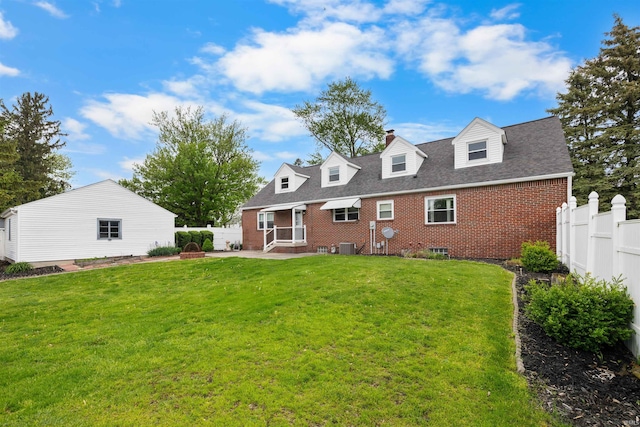 501 N Van Buren St, Auburn, IN 46706 - rear view of house featuring a fenced backyard, brick siding, a patio, entry steps, and roof with shingles