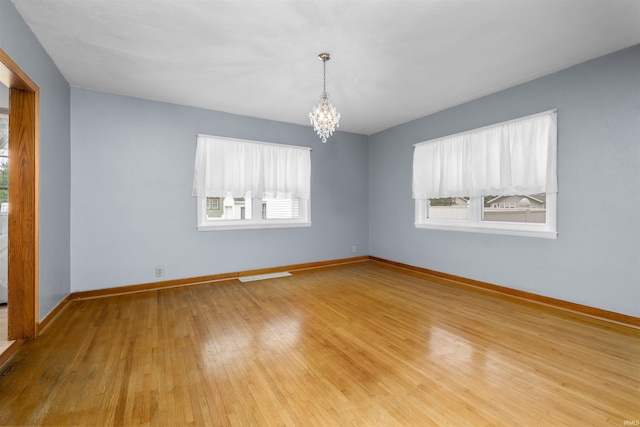 501 N Van Buren St, Auburn, IN 46706 - empty room featuring a chandelier and light wood-style flooring