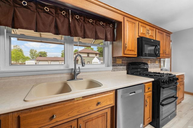501 N Van Buren St, Auburn, IN 46706 - kitchen featuring black appliances, brown cabinets, healthy amount of natural light, and light wood finished floors