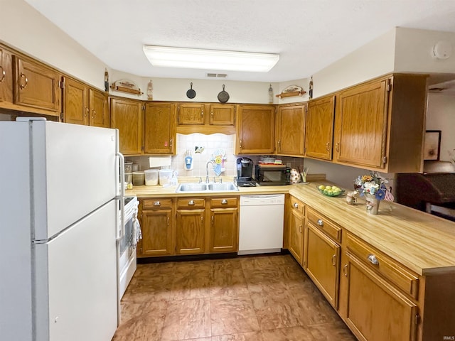 4329 Rutgers Dr Unit 40B, Anderson, IN 46013 - kitchen with white appliances, light countertops, and brown cabinetry