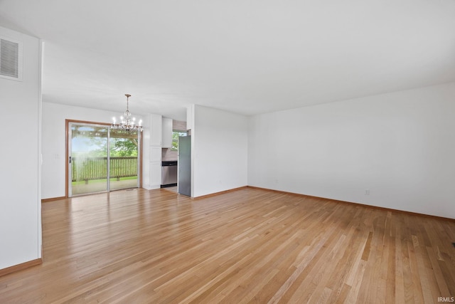 8416 S 400 W, Lafayette, IN 47909 - empty room featuring a chandelier and light wood finished floors