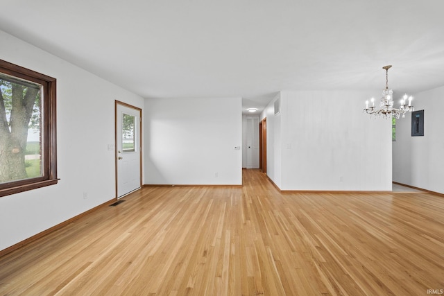 8416 S 400 W, Lafayette, IN 47909 - unfurnished living room featuring electric panel, light wood finished floors, and a chandelier