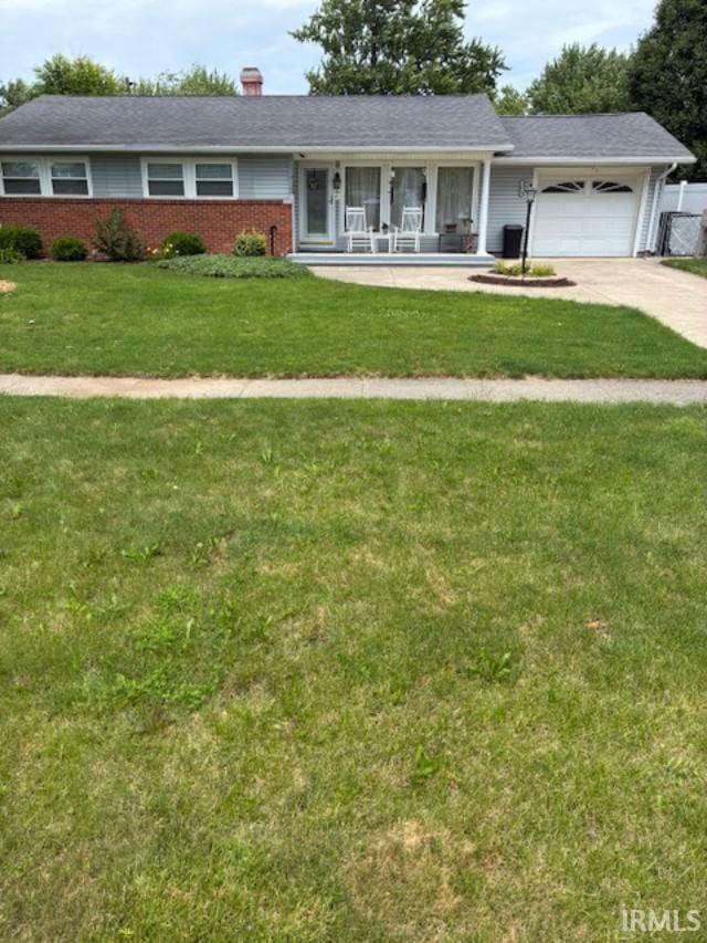 1814 W Kem Rd, Marion, IN 46952 - ranch-style home with a garage, driveway, brick siding, covered porch, and a chimney