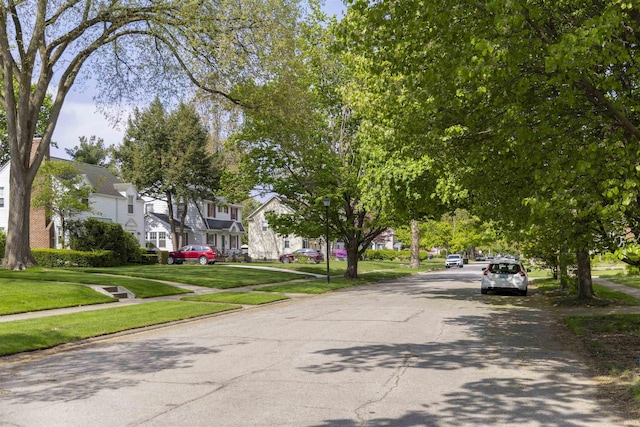 1621 E Madison St, South Bend, IN 46617 - view of asphalt road featuring a residential view, sidewalks, and street lights