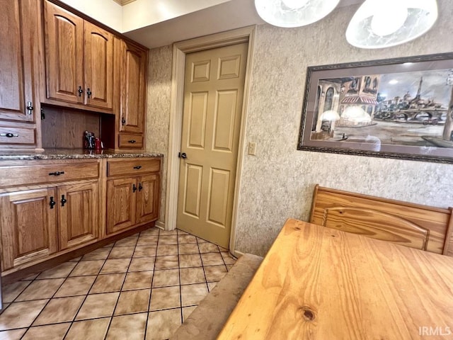 408 Duryea Dr, Auburn, IN 46706 - kitchen with light tile patterned floors, wooden counters, and brown cabinets