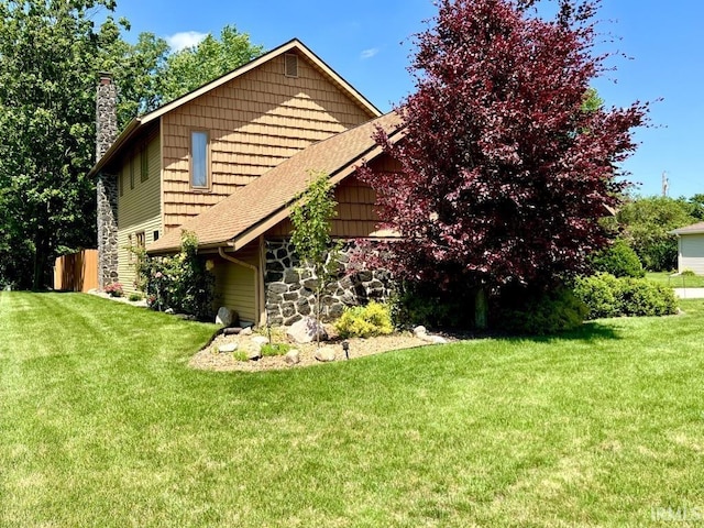 408 Duryea Dr, Auburn, IN 46706 - view of property exterior featuring a chimney, stone siding, and a shingled roof