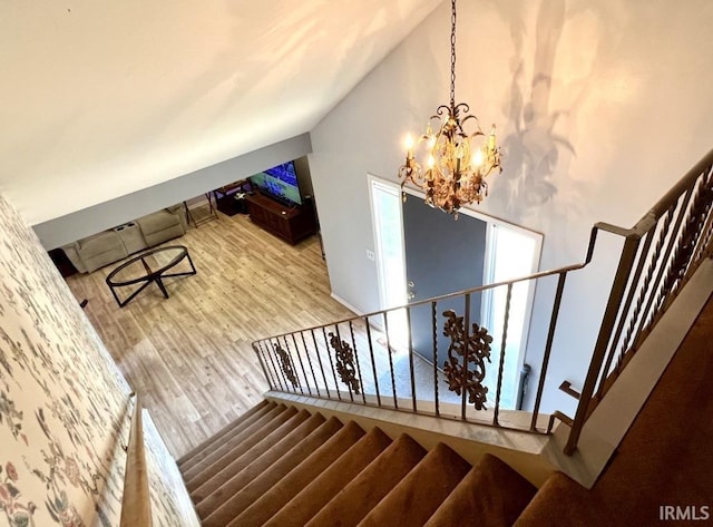 408 Duryea Dr, Auburn, IN 46706 - staircase with wood finished floors, a chandelier, and high vaulted ceiling
