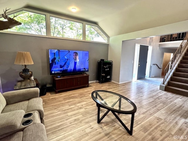 408 Duryea Dr, Auburn, IN 46706 - living room with lofted ceiling, wood finished floors, plenty of natural light, and stairs