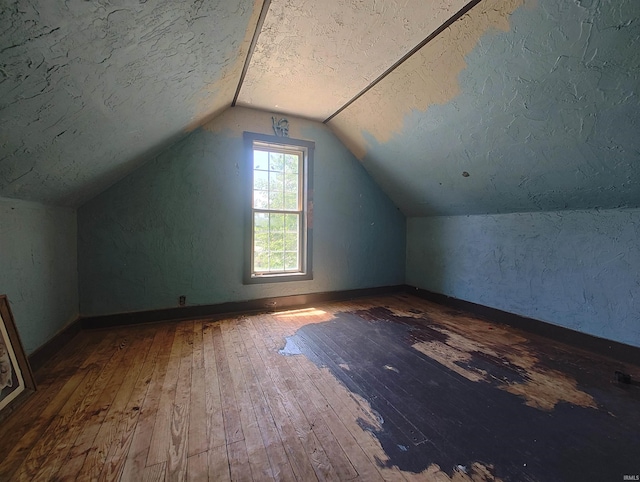 307 W Bender St, Knox, IN 46534 - additional living space with hardwood / wood-style floors, vaulted ceiling, and a textured ceiling