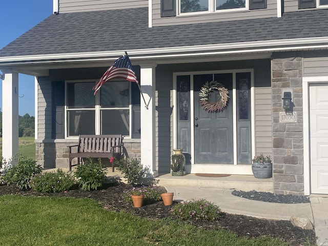 17030 Hand Rd, Huntertown, IN 46748 - entrance to property with roof with shingles, stone siding, and covered porch