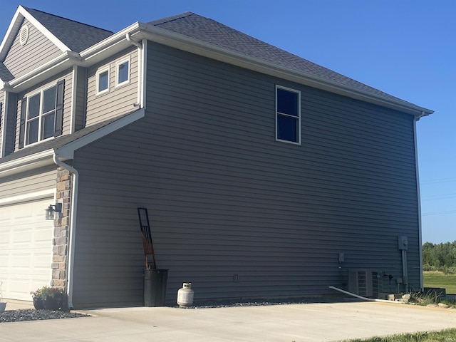 17030 Hand Rd, Huntertown, IN 46748 - view of home's exterior with a garage and stone siding