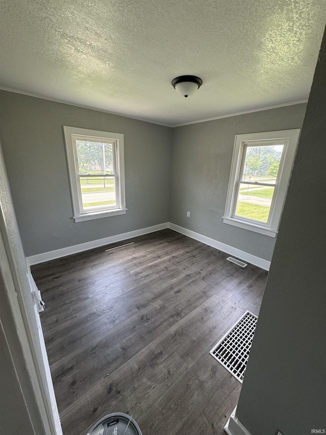 118 Burns Blvd, Fort Wayne, IN 46807 - empty room with a textured ceiling, healthy amount of natural light, and dark wood-type flooring