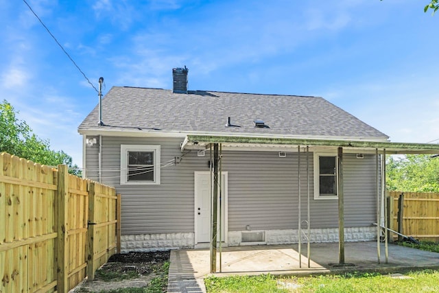 118 Burns Blvd, Fort Wayne, IN 46807 - back of house with a fenced backyard, a patio, a chimney, and a shingled roof