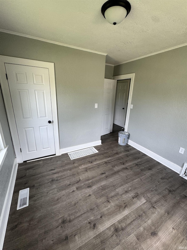 118 Burns Blvd, Fort Wayne, IN 46807 - unfurnished bedroom with crown molding, dark wood-type flooring, and a textured ceiling