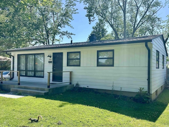 2407 Sherborne Blvd, Fort Wayne, IN 46805 - ranch-style home with a front lawn, board and batten siding, and a chimney