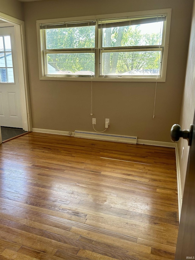 2407 Sherborne Blvd, Fort Wayne, IN 46805 - spare room featuring a baseboard heating unit and wood-type flooring