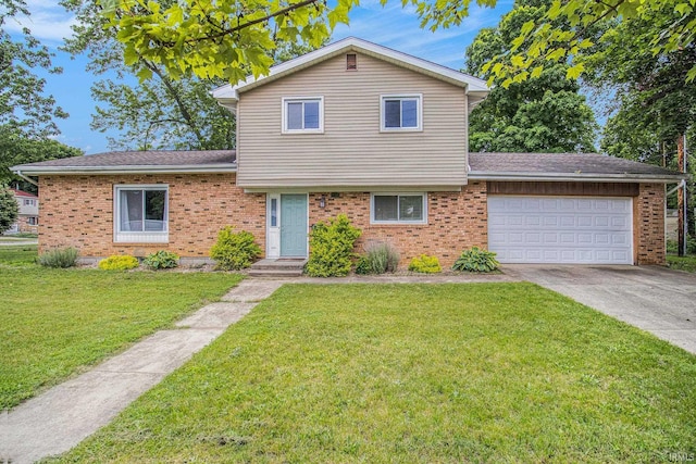 1822 Sherman Ave, South Bend, IN 46616 - split level home featuring concrete driveway, an attached garage, a front yard, and brick siding