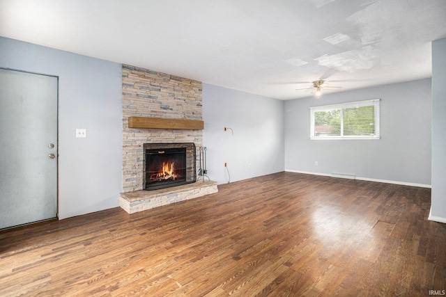 1822 Sherman Ave, South Bend, IN 46616 - unfurnished living room with wood finished floors, a ceiling fan, and a stone fireplace