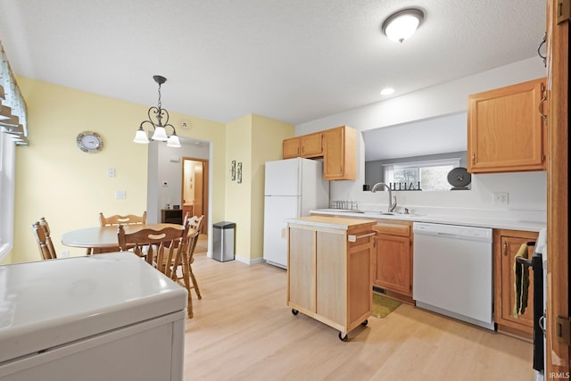 8620 Shearwater Pass, Fort Wayne, IN 46825 - kitchen featuring white appliances, light wood finished floors, light countertops, and hanging light fixtures
