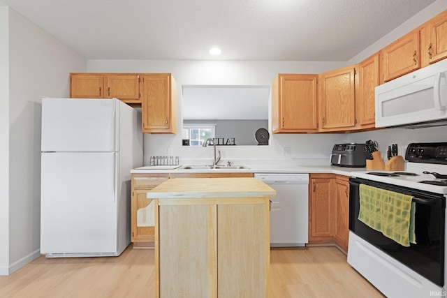 8620 Shearwater Pass, Fort Wayne, IN 46825 - kitchen featuring white appliances, light countertops, light wood-style floors, a center island, and recessed lighting