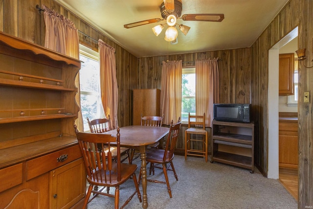 517 S Edison Ave, South Bend, IN 46619 - dining area with ceiling fan, light colored carpet, and wood walls