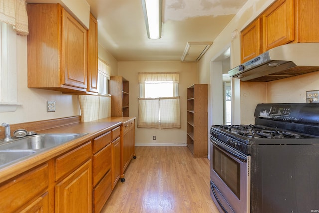 517 S Edison Ave, South Bend, IN 46619 - kitchen featuring gas range, under cabinet range hood, light wood-style flooring, and brown cabinets