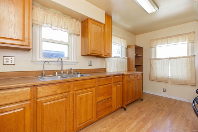 517 S Edison Ave, South Bend, IN 46619 - kitchen featuring light wood-style floors, healthy amount of natural light, and brown cabinetry