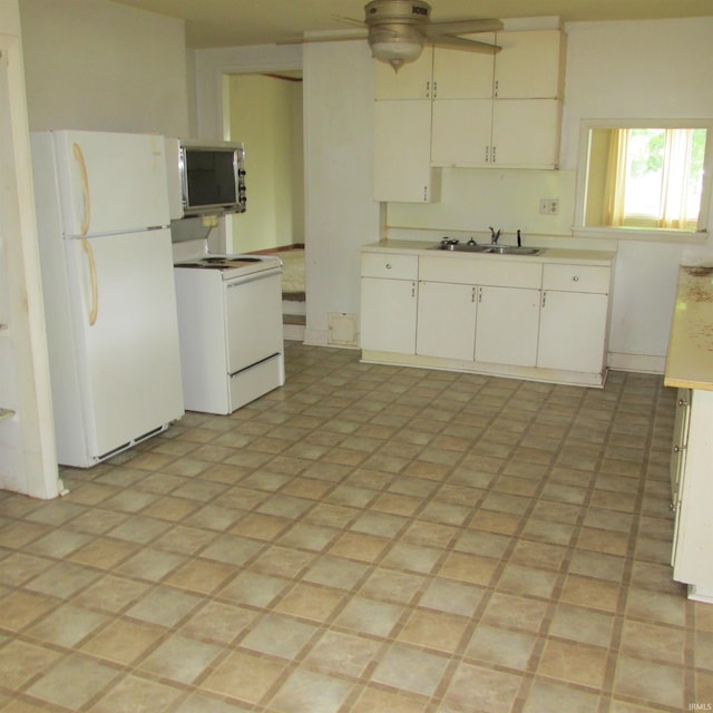 9219 N 100 W, West Lafayette, IN 47906 - kitchen with white appliances, ceiling fan, light countertops, and white cabinetry