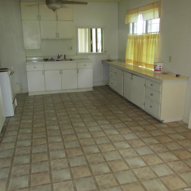 9219 N 100 W, West Lafayette, IN 47906 - kitchen with a ceiling fan, white cabinetry, and light countertops