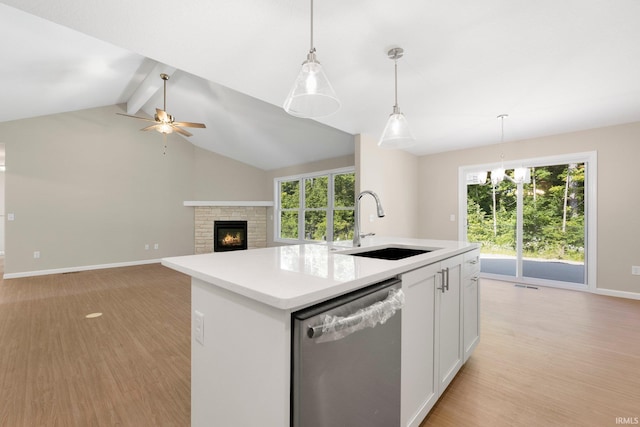 13969 Diavik Pl, Fort Wayne, IN 46845 - kitchen with stainless steel dishwasher, a ceiling fan, light wood finished floors, white cabinetry, and light countertops