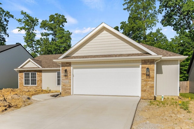 13969 Diavik Pl, Fort Wayne, IN 46845 - single story home with stone siding, an attached garage, concrete driveway, and a shingled roof