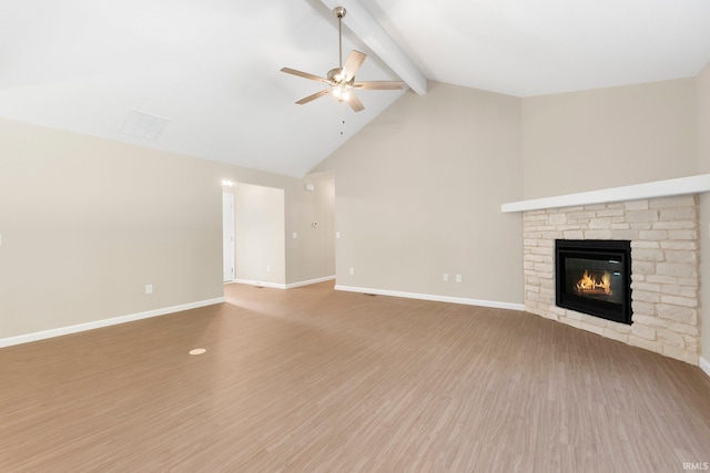 13969 Diavik Pl, Fort Wayne, IN 46845 - unfurnished living room with a ceiling fan, a stone fireplace, beamed ceiling, wood finished floors, and high vaulted ceiling
