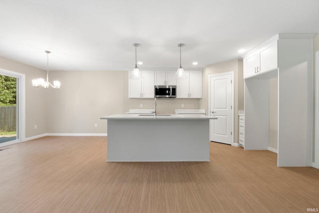 13969 Diavik Pl, Fort Wayne, IN 46845 - kitchen with stainless steel microwave, recessed lighting, light wood-style floors, light countertops, and white cabinetry