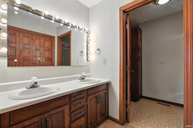 708 Forest Dr, Frankfort, IN 46041 - full bath with double vanity, a closet, tile patterned floors, and a textured ceiling