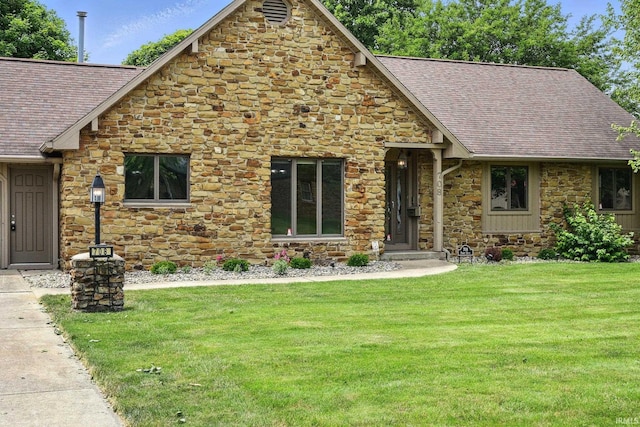708 Forest Dr, Frankfort, IN 46041 - tudor home with stone siding, roof with shingles, and a front yard