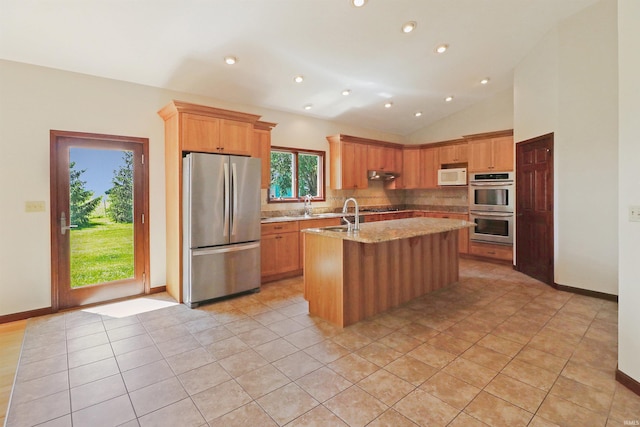 9932 N Meridian Line Rd, West Lafayette, IN 47906 - kitchen with appliances with stainless steel finishes, tasteful backsplash, a kitchen island with sink, vaulted ceiling, and light stone counters