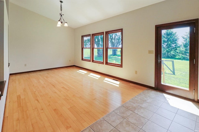 9932 N Meridian Line Rd, West Lafayette, IN 47906 - spare room with light wood-style floors, a chandelier, and lofted ceiling