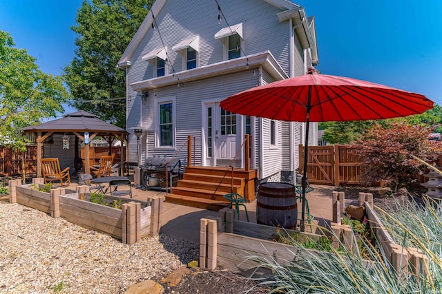 650 Main St, Rockport, IN 47635 - rear view of property featuring a garden, a gazebo, and a patio area