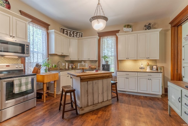 650 Main St, Rockport, IN 47635 - kitchen featuring appliances with stainless steel finishes, tasteful backsplash, and healthy amount of natural light