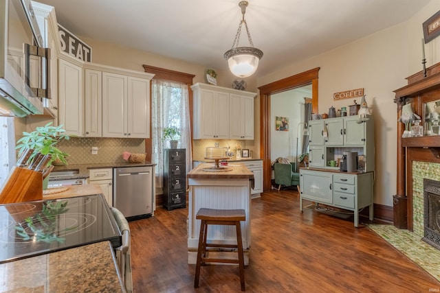 650 Main St, Rockport, IN 47635 - kitchen with appliances with stainless steel finishes, decorative backsplash, dark wood-style floors, a fireplace with flush hearth, and hanging light fixtures
