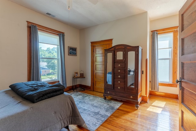 650 Main St, Rockport, IN 47635 - bedroom with light wood-type flooring, multiple windows, and a ceiling fan