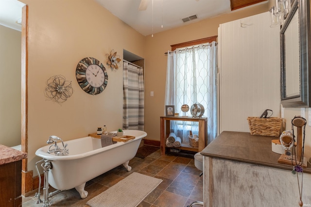 650 Main St, Rockport, IN 47635 - bathroom with a freestanding bath, stone finish floors, a ceiling fan, and vanity